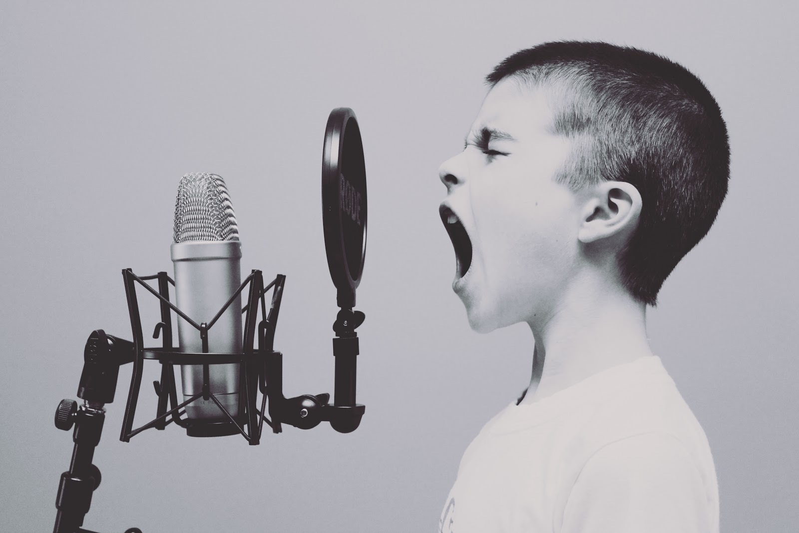 Close up of boy yelling into microphone