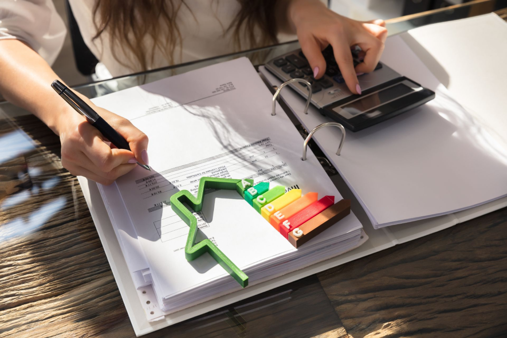  A woman drafts an energy performance audit of her home. 