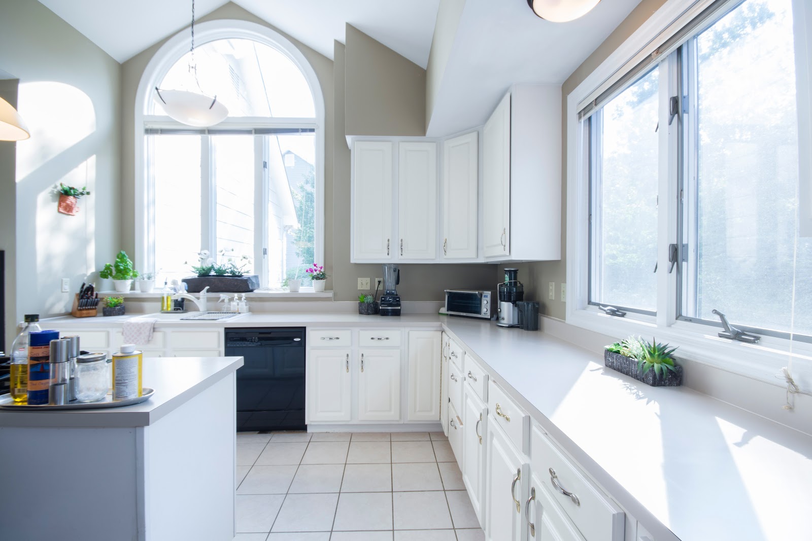 White kitchen with large open windows and natural light